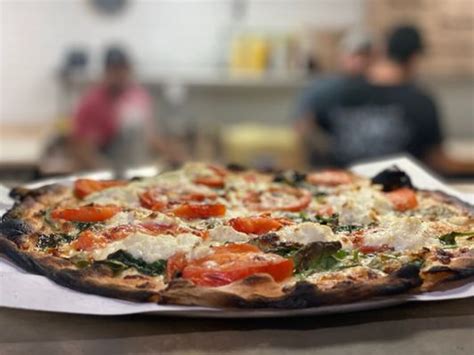 The shop features a specialized coal-fired pizza oven, flown in directly from Italy. . Fuoco apizza